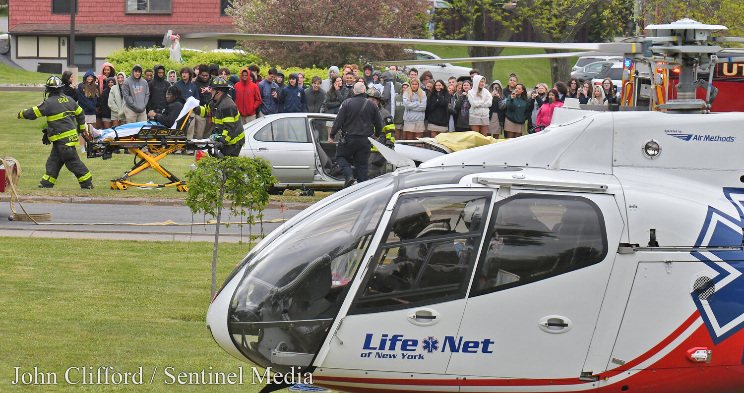 Students at Notre Dame Junior/Senior High School in Utica  had an up-close look at the potential tragic consequences of drunk driving  on May 17, 2023. A Mock DWI crash scene was set on the school’s front lawn that brought  dozens of first responders. Pictured, Utica Fire Department and a LifeNet helicopter EMT wheel a gurney to the helicopter for transport.