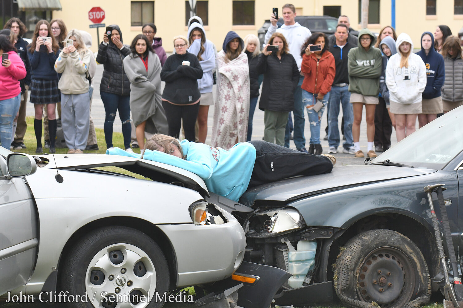 Students at Notre Dame Junior/Senior High School in Utica  had an up-close look at the potential tragic consequences of drunk driving  on May 17, 2023. A Mock DWI crash scene was set on the school’s front lawn that brought  dozens of first responders. Pictured, the "deceased" student actor with classmates in the background.