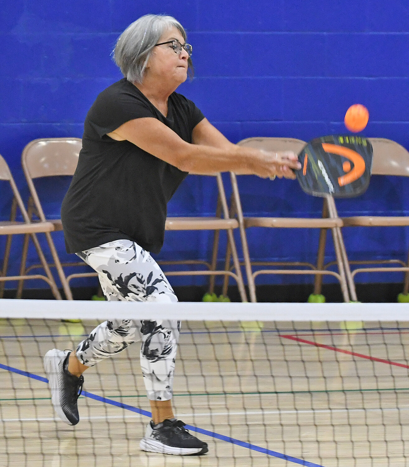 Rosanne Hart makes a return during pickleball play Thursday evening at the Jewish Community Center.