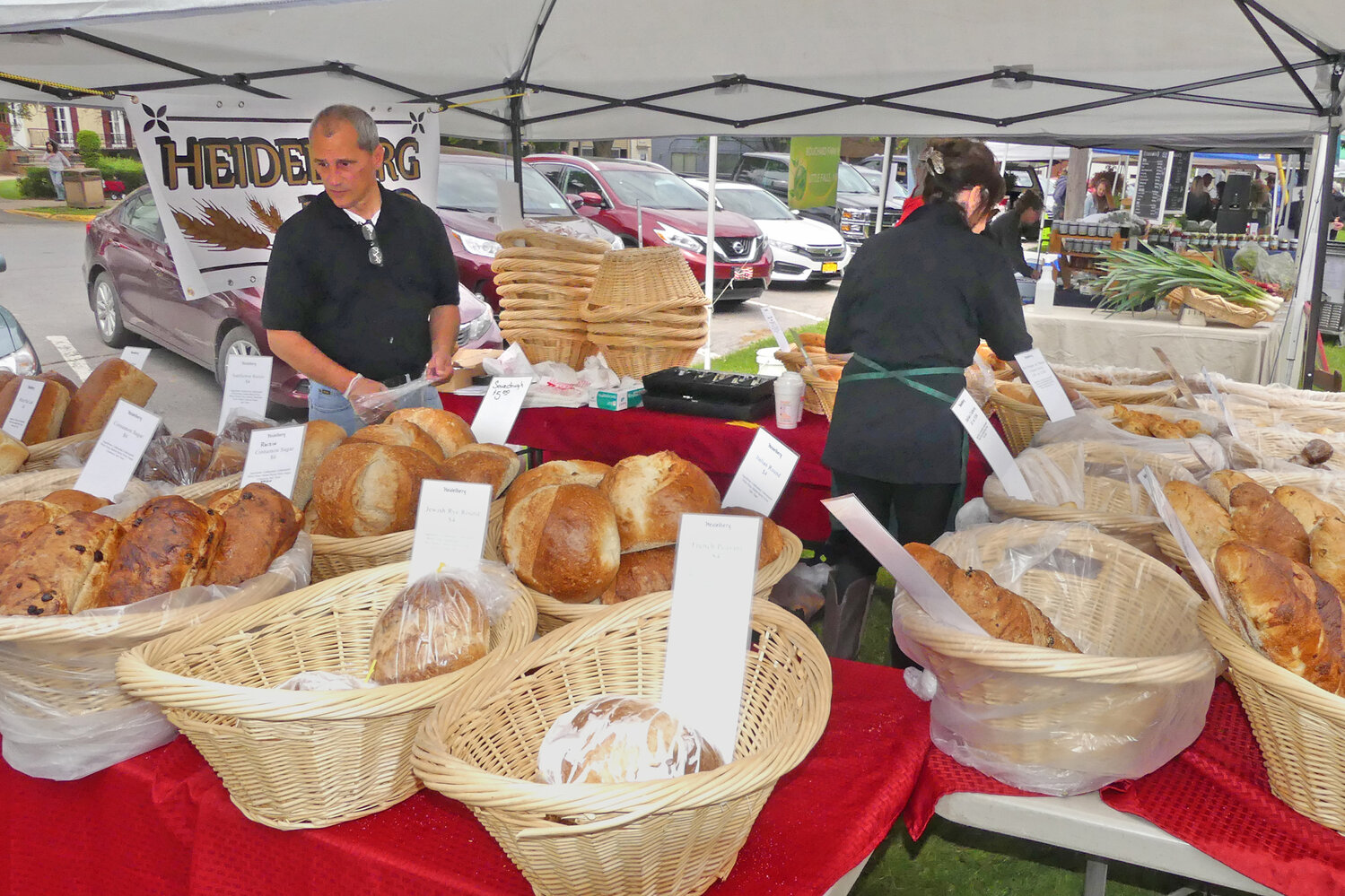 Teresa and David Bunces of Heidlberg Bread stock their bread baskets at Clinton Farmers Market.