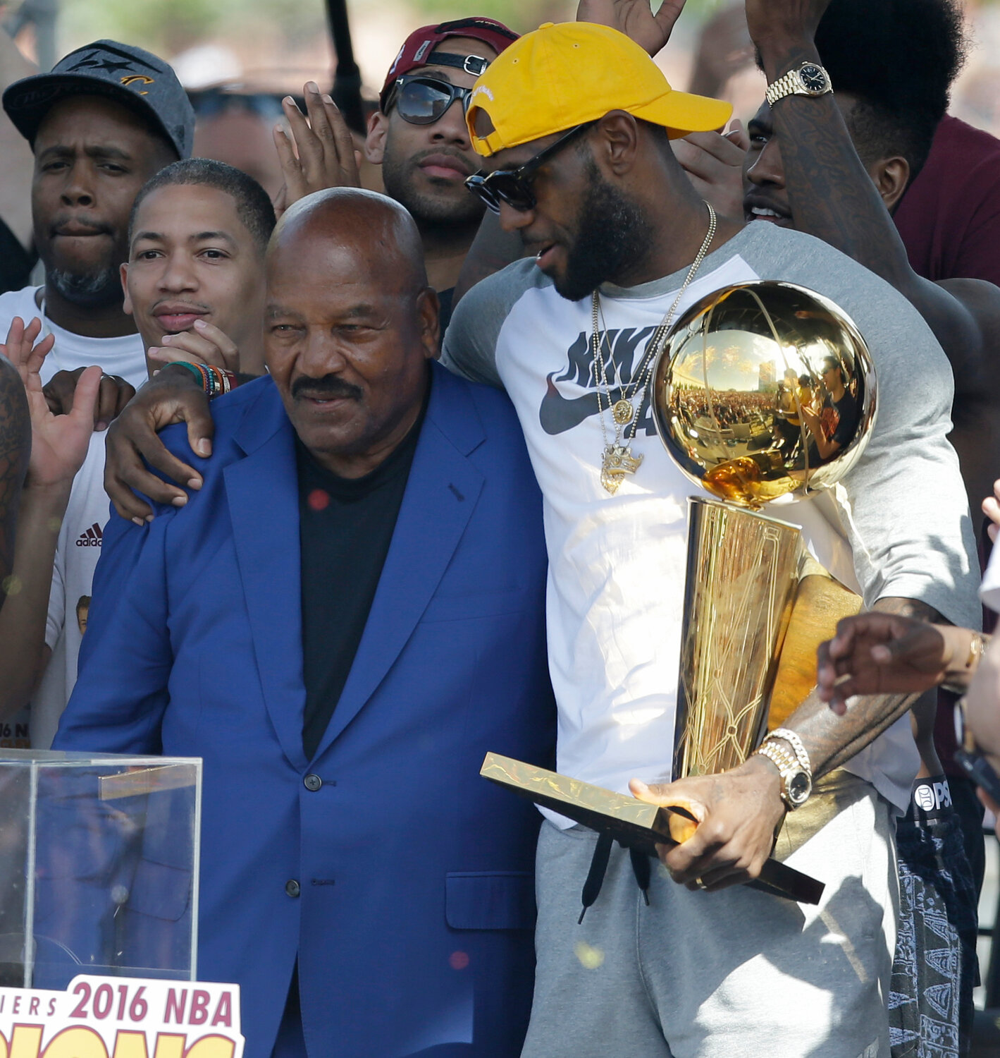 Former Cleveland Browns player Jim Brown, left, gets a hug from LeBron James, who holds the Larry O'Brien NBA championship trophy during a rally June 22, 2016, in Cleveland. “I hope every Black athlete takes the time to educate themselves about this incredible man and what he did to change all of our lives,” James posted shortly after Brown's death. ”We all stand on your shoulders Jim Brown. If you grew up in Northeast Ohio and were Black, Jim Brown was a God."