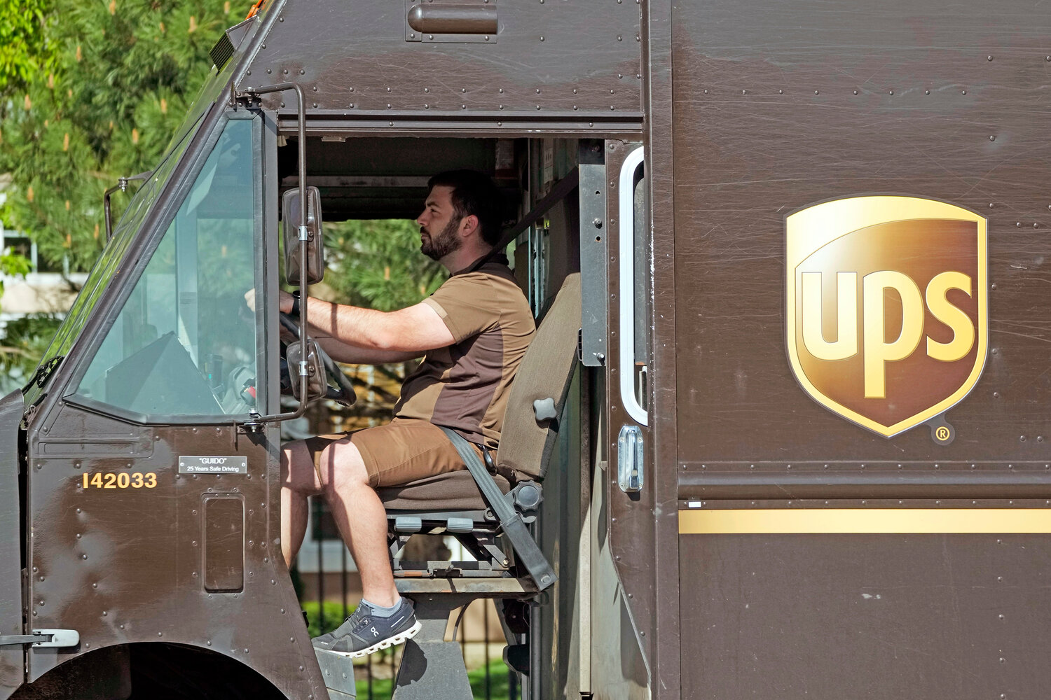 A UPS truck makes deliveries in Northbrook, Ill., Wednesday, May 10. More than 340,000 unionized United Parcel Service employees, including drivers and warehouse workers, say they are prepared to strike if the company does not meet their demands before the end of the current contract on July 31.