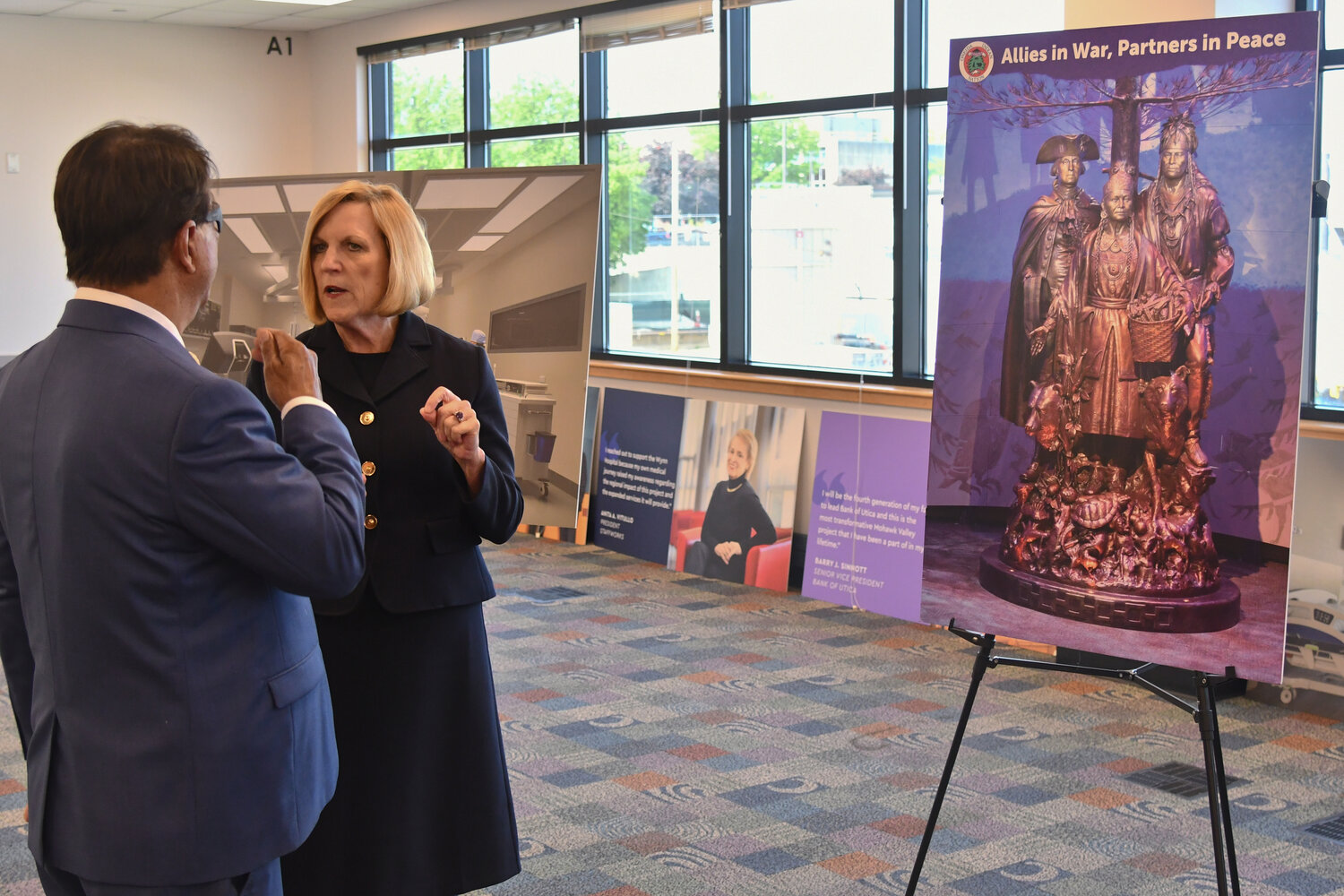 Ray Halbritter, CEO of Oneida Nation Enterprises and representative for the Oneida Indian Nation, and Darlene Stromstad, president and CEO of MVHS, discuss their continued partnership after announcing the $1 million donation from the Oneida Indian Nation on Tuesday. To the right is a depiction of what the bronze statue will look like at the entrance to the Wynn Hospital.