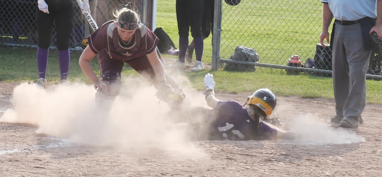 Holland Patent's Terralyn McLaughlin slides safely into home ahead of the throw against Clinton on Monday in the Section III Class B first-round game. HP won 22-1.