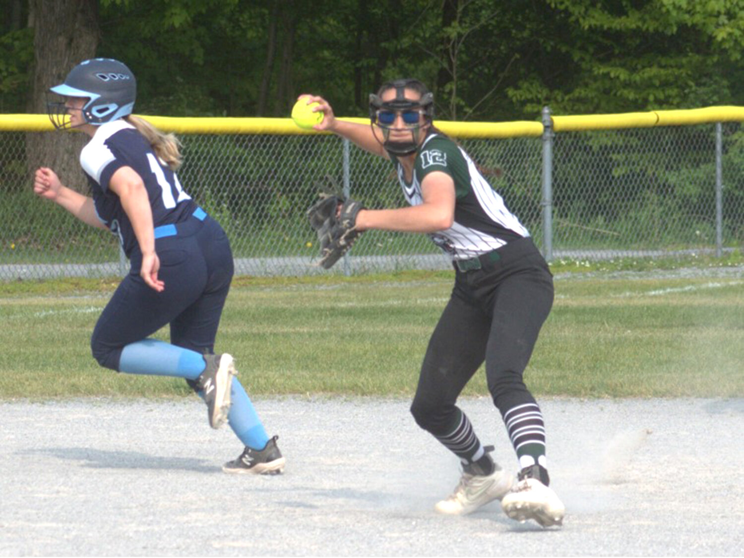 Adirondack infielder Kaitlyn Spann looks to throw to first as Central Valley Academy baserunner Brooke Burns tries to advance during Tuesday's Class B second round game in Boonville.