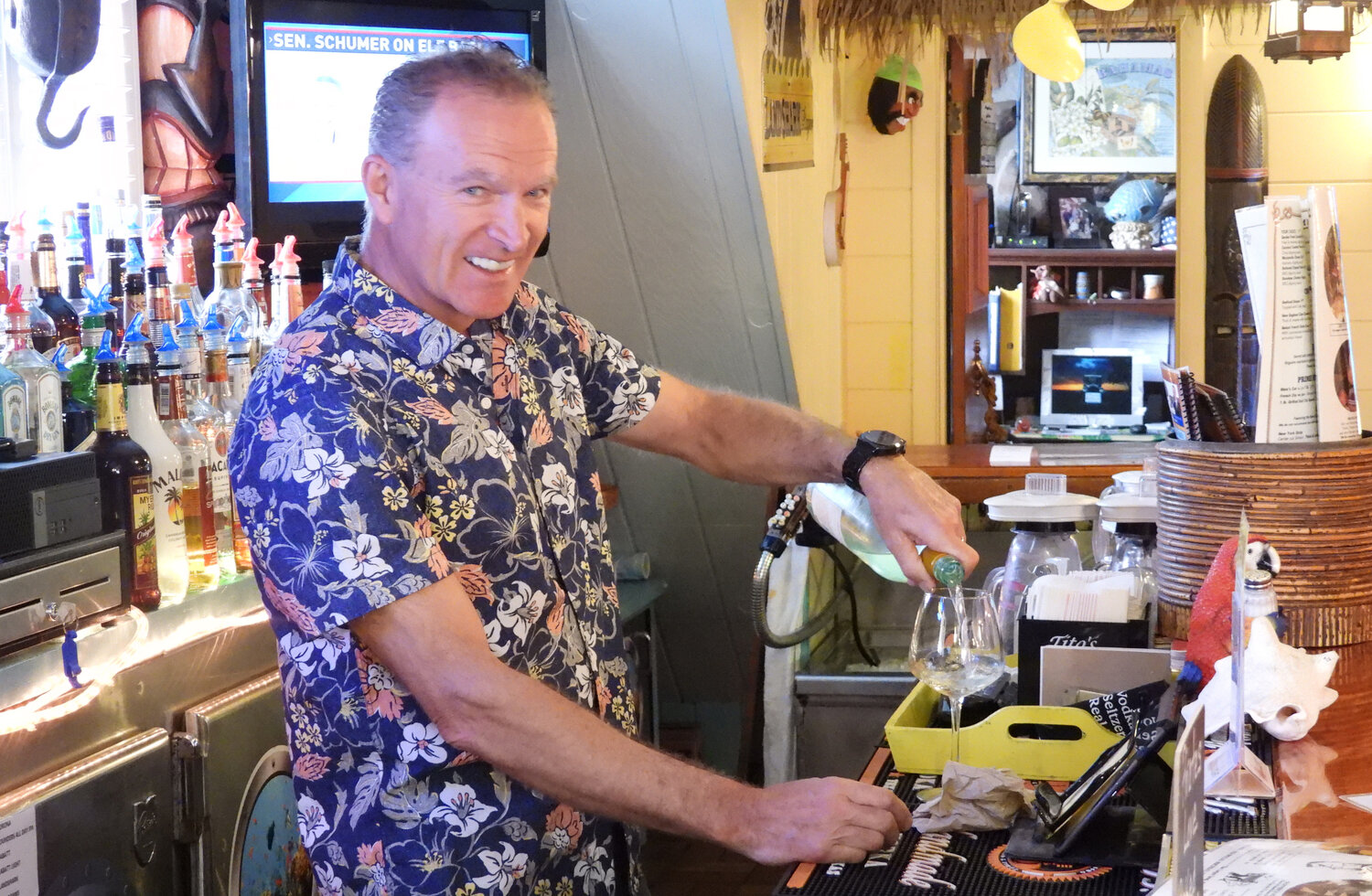 Andy Brown manages the Shipwreck Bar and Grill at Captain John's and is pictured here pouring a drink.