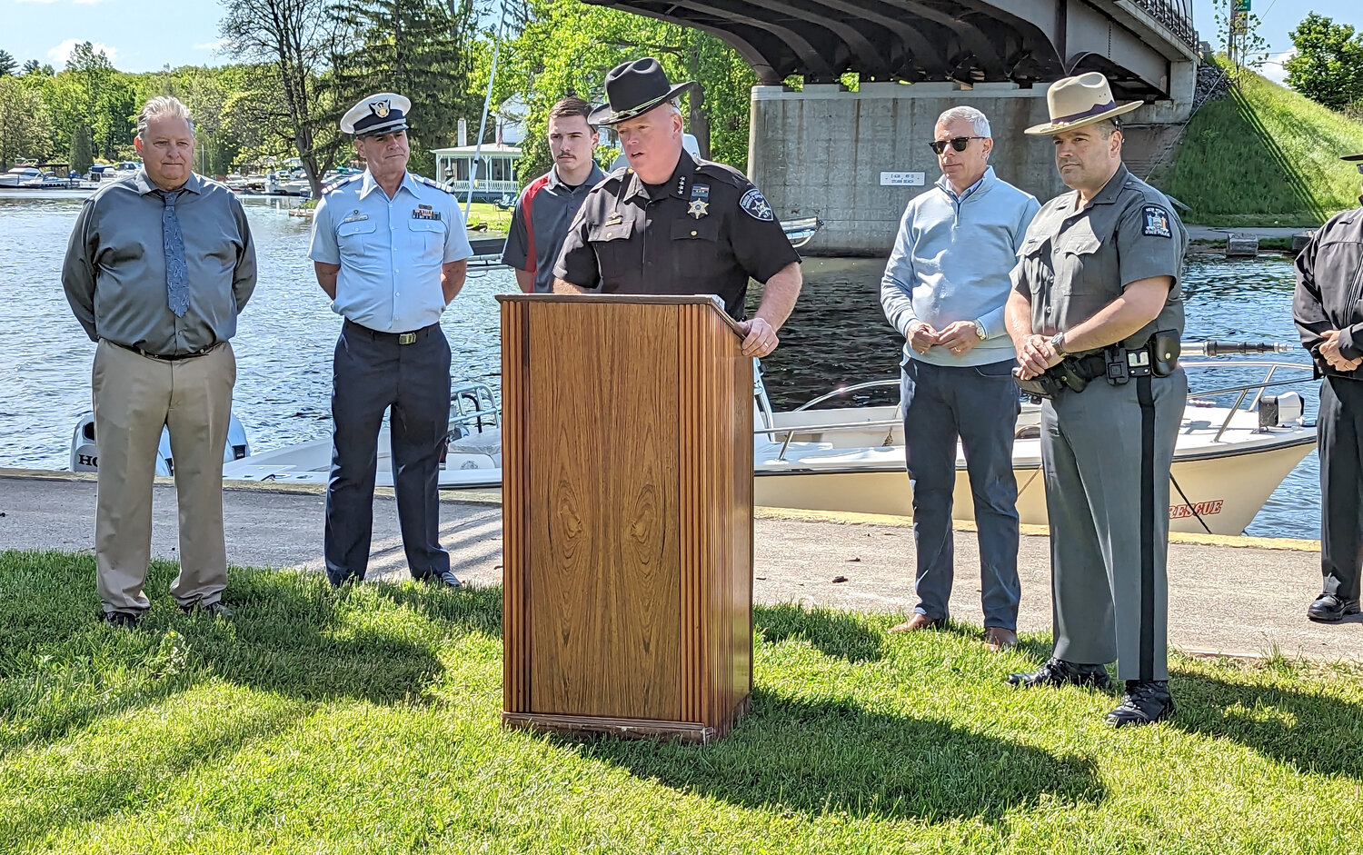 Oneida County Sheriff Robert M. Maciol discusses boater safety with other county leaders alongside the Barge Canal in Sylvan Beach Thursday morning. From left: Sylvan Beach Mayor Richard Sullivan, U.S. Coast Guard Auxiliary Flotilla Commander John P. Conroy, Sylvan Beach Fire Lt. Colin Isom, Maciol, Oneida County Executive Anthony J. Picente, and New York State Police Lt. Francis LaBarbera.
