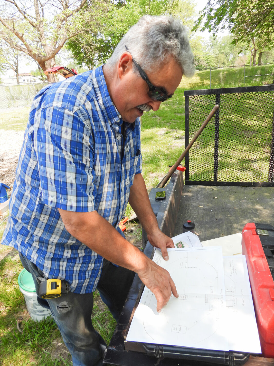OIC Member and Volunteer Joseph Magliocca looks over some of the plans for the Oneida Dog Park and points out where certain obstacles and structures would go