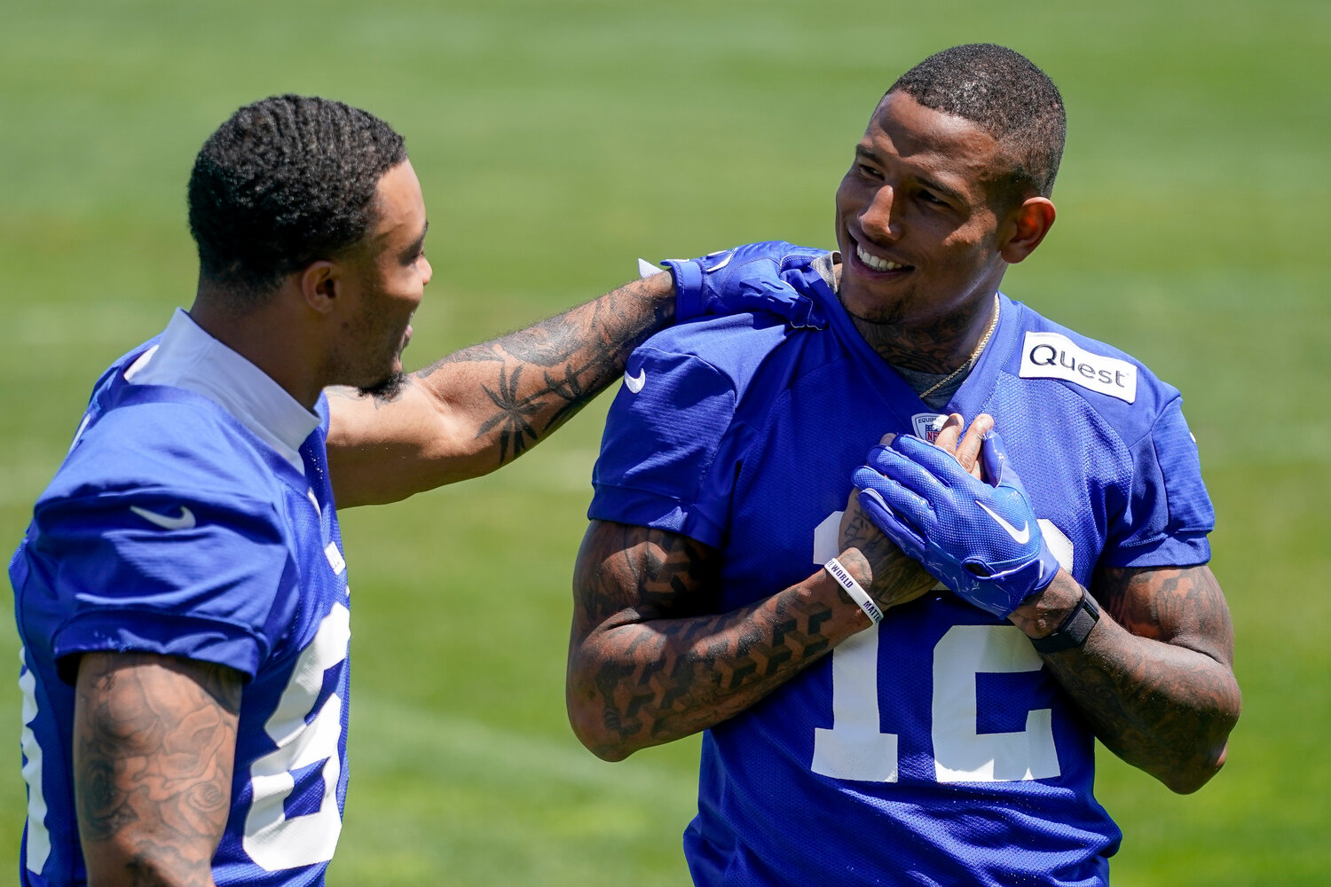 New York Giants tight end Darren Waller, right, walks off the field with Lawrence Cager after workouts at the team’s practice facility on Thursday in East Rutherford, N.J.