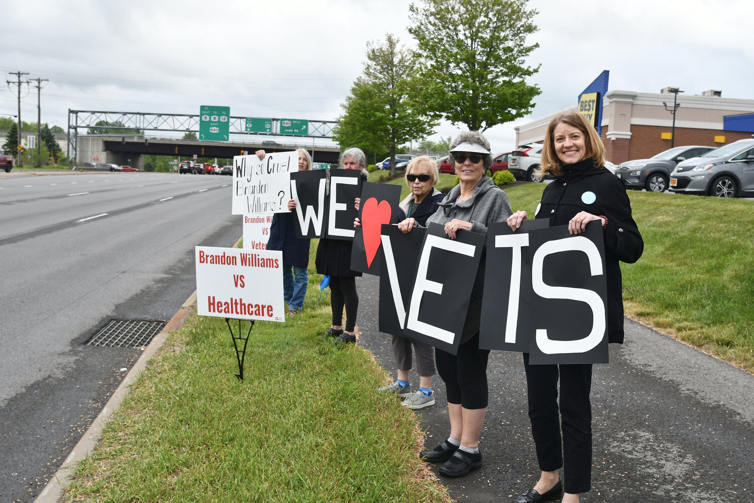 NY-22 residents rally outside of Consumer Square in New Hartford on May 24, protesting against Rep. Brandon Williams' yes vote on the Limit, Save, Grow Act of 2023.