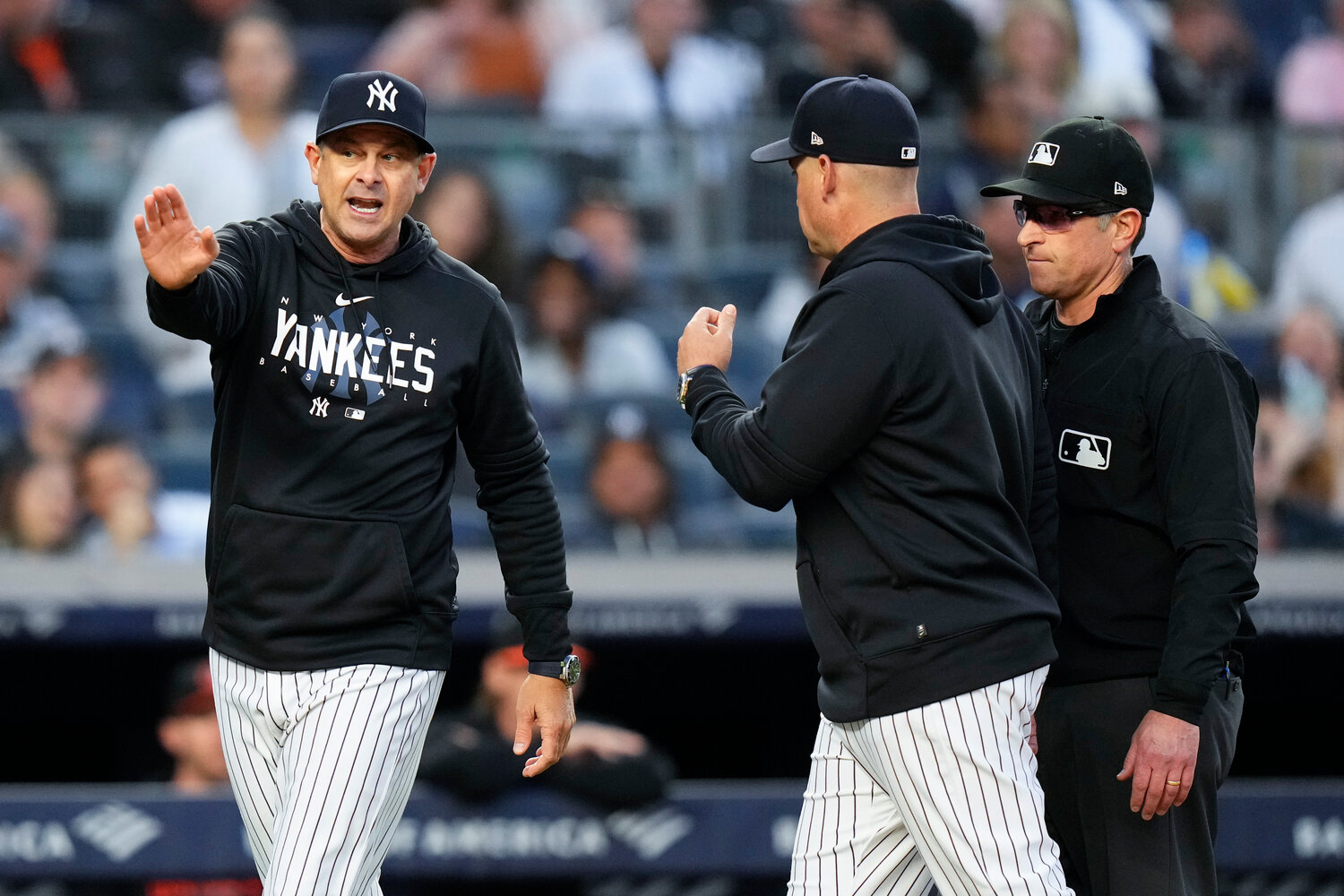 New York Yankees manager Aaron Boone, left, argues with umpire Chris Guccione, right, after Boone was ejected during the third inning of the team's game against the Baltimore Orioles on Thursday night in New York.