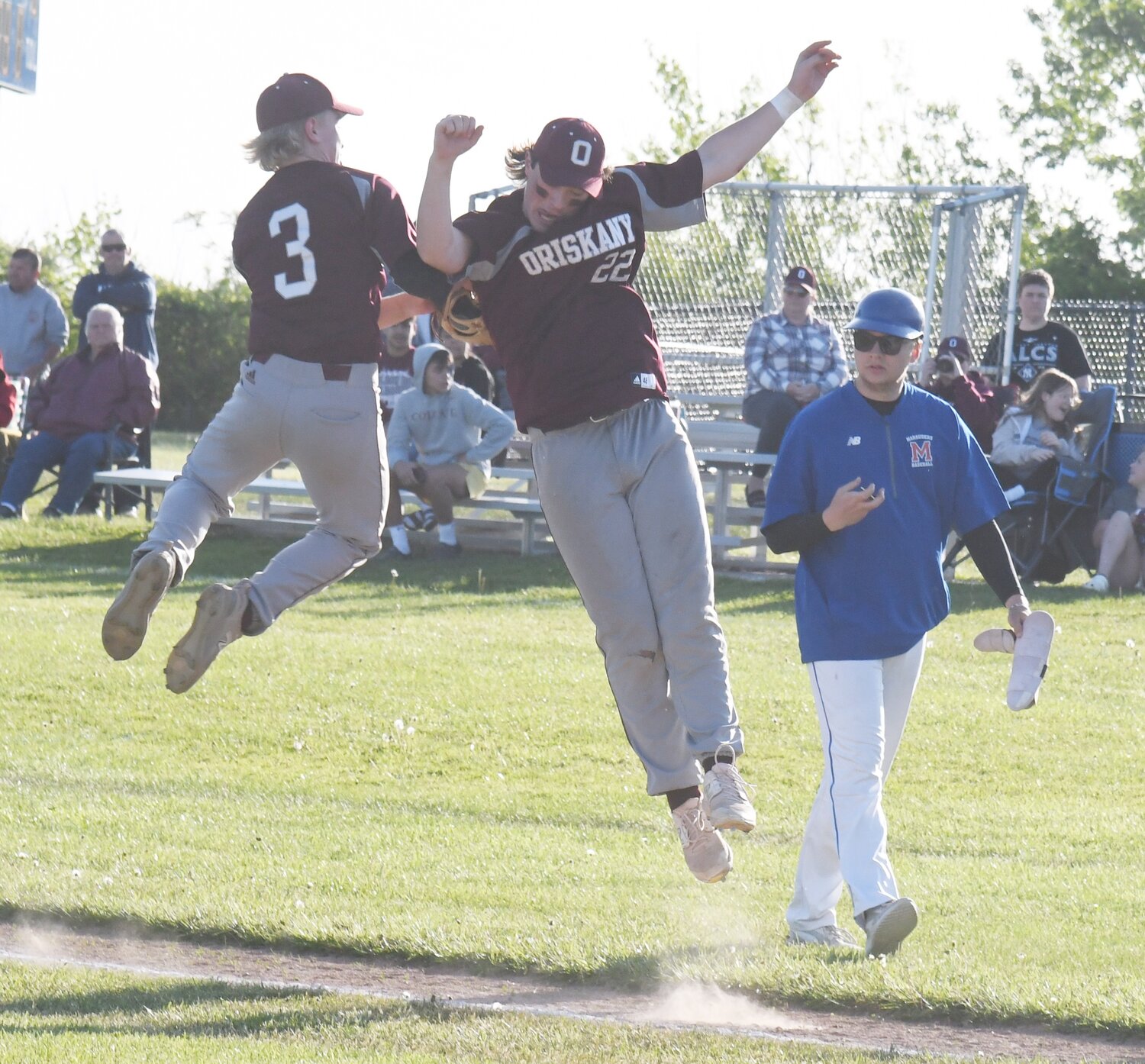 Oriskany’s Eddie Wright (3) and Noah Narolis celebrate after the team earned a 10-3 win over host New York Mills in a Section III Class D game. Wright earned the win on the mound, going 6 1/3 innings.