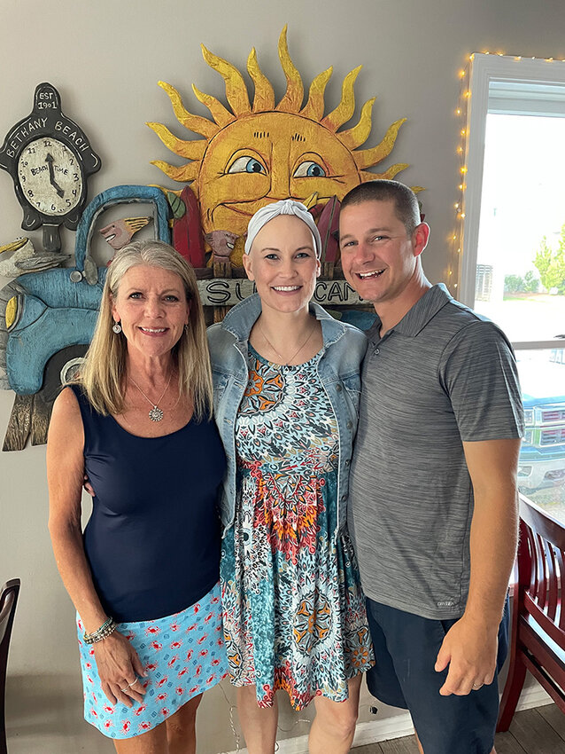 Before her death in 2021, Katherine Mueller (center) advocated for fellow cancer patients through fundraising and research along with her family and friends including her mother Robin (left), husband Matt (right) and stepfather Larry.