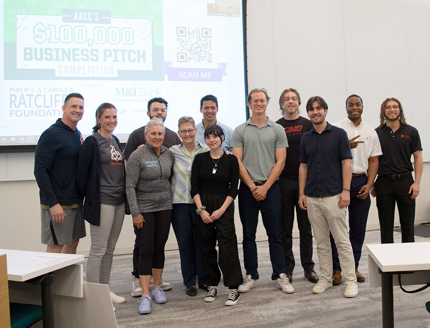 Gaetano Ailiff (center) won the top prize of $25,000, presented by AACC Entrepreneurial Studies Institute Academic Chair and Associate Professor Stephanie Goldenberg, to expand his business, MD Junk and Moving, which he owns and operates with his cousin Richard Ward (left).