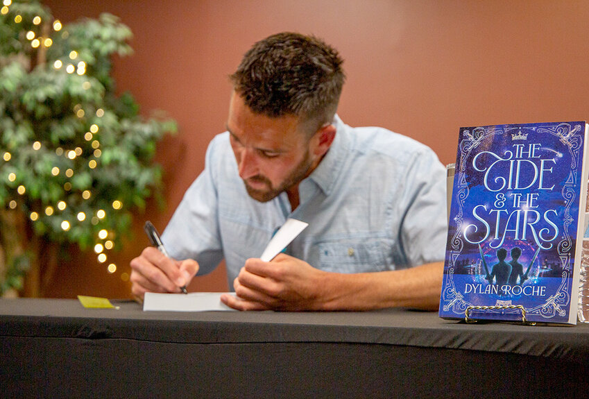Dylan Roche signed copies of “The Tide & the Stars” at Park Books on June 11.