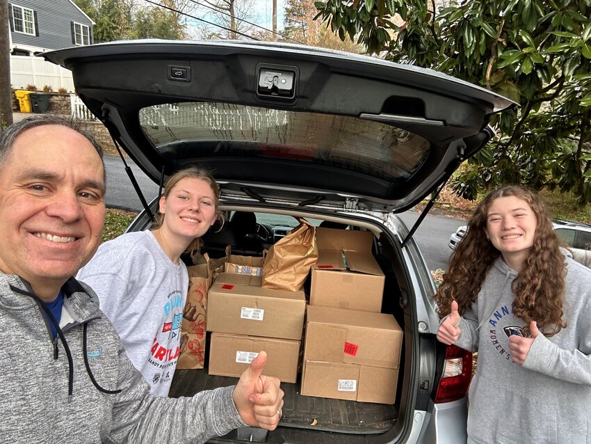 (L-R) Neighborhood captain Steve Haris and volunteers Samantha and Addison Johns helped their community, Winchester on the Severn, collect more items than any other neighborhood during the Good Neighbors Group’s 2025 S(o)uper Bowl food drive.