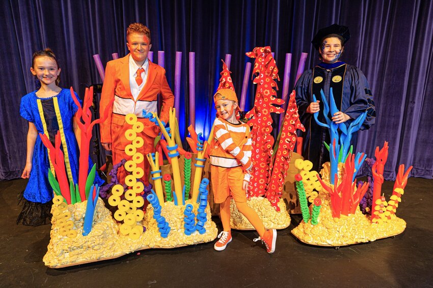 Sarabelle Stephens (Dory), John Lyons (Marlin), Hannah Koloski (Nemo) and Asher Schropp (Professor Ray) posed in front of underwater props on the stage for “Finding Nemo Jr.”