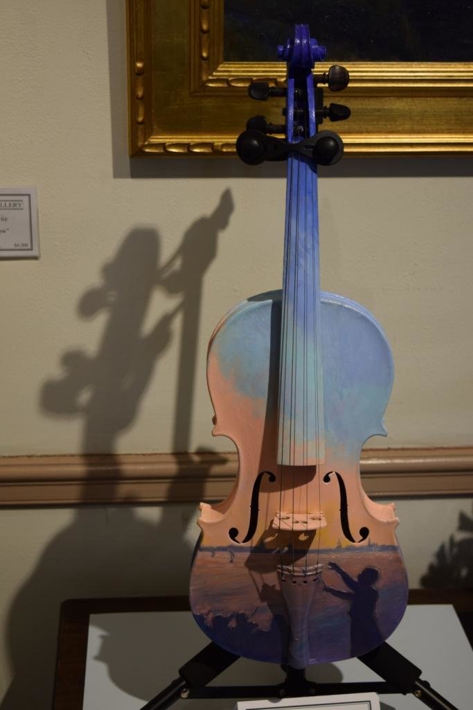 Melissa Gryder, an Arnold resident, painted the view of the sunset from Jonas Green Park on her violin.