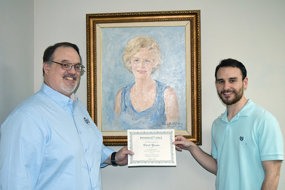 Caring Cupboard LLC President Chuck Yocum received his Volunteer of the Month award from Voice Assistant Editor Zach Sparks.