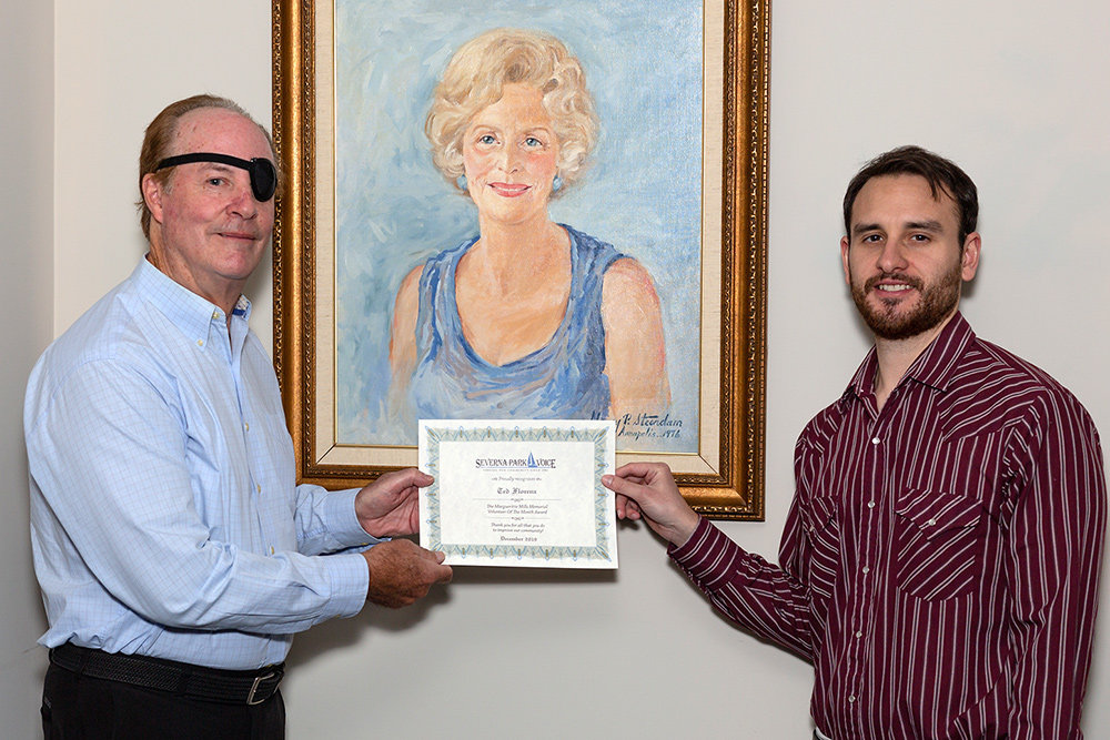 Ted Florenz received the December Volunteer of the Month certificate from Severna Park Voice Editor Zach Sparks.