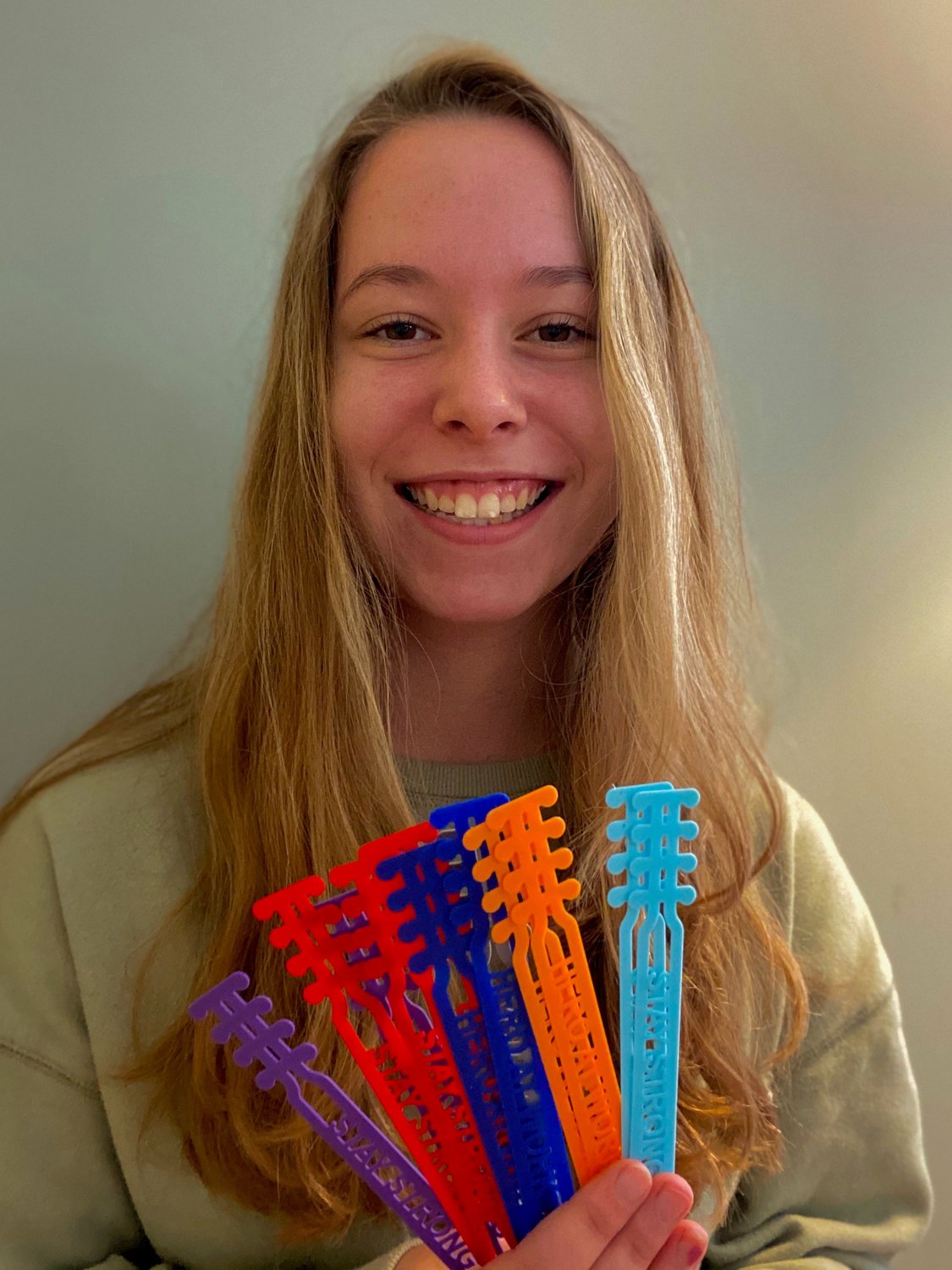 Delia Fishburne, a Severna Park High School junior, held some of the more than 100 ear savers she has created for frontline clinical team members. She is working on an order of 150 that will be donated to Hospice of the Chesapeake.