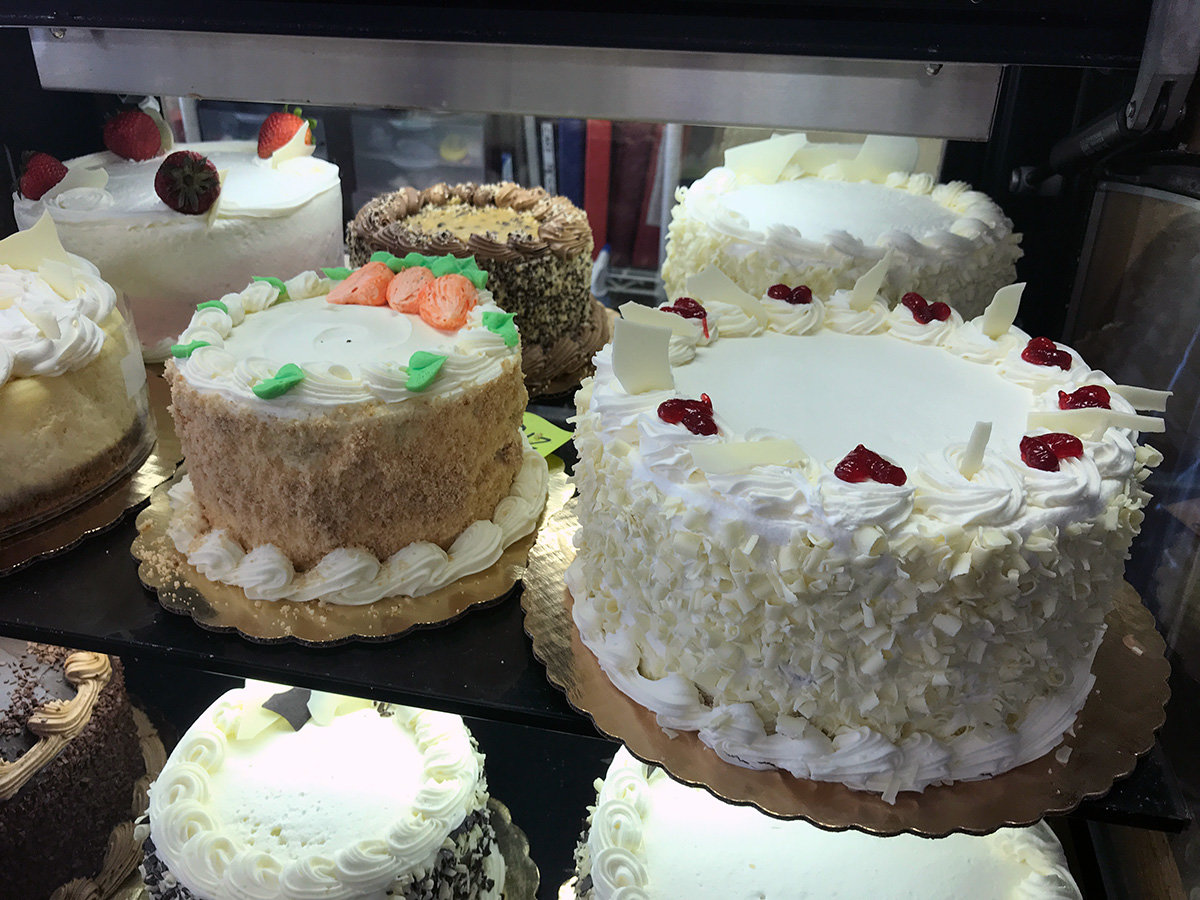 At Cakes and Confections Bakery Café, the most popular cake is the vanilla raspberry (far right). With rich buttercream icing covering a vanilla cake with raspberry swirled within, it's a winner.