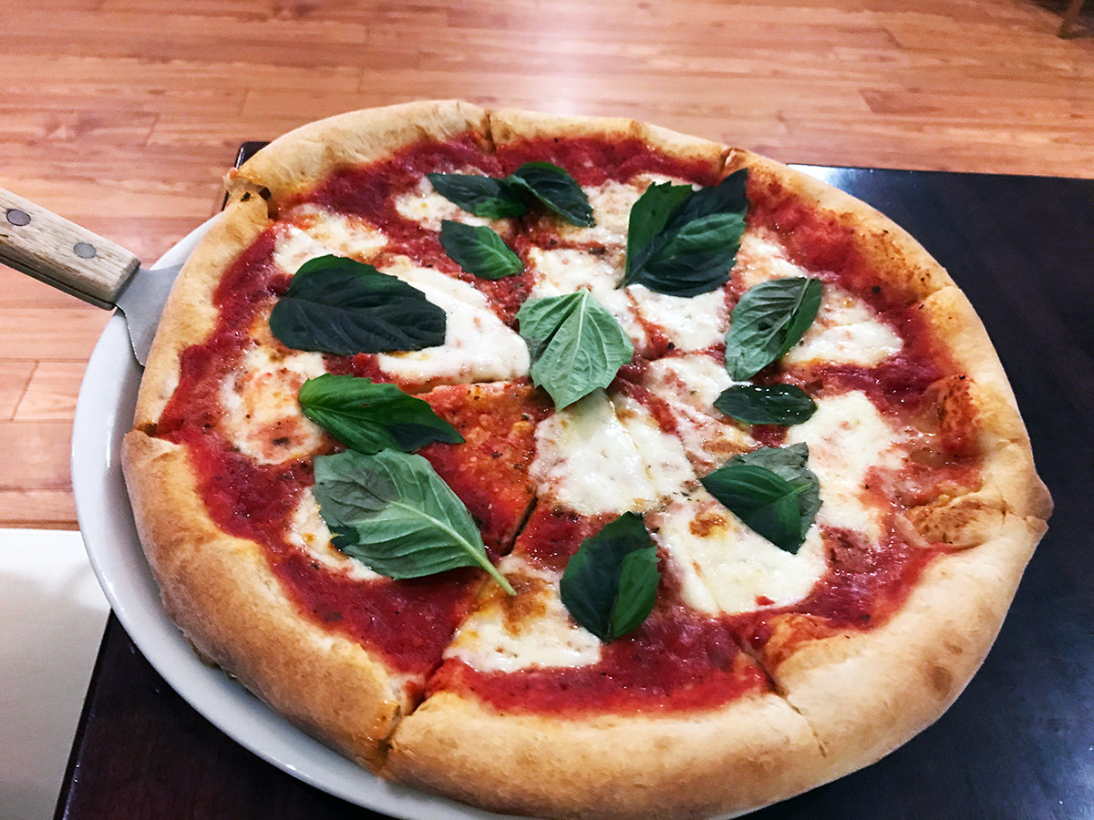 The margherita pizza was classic with thick cheese and fresh basil leaves.