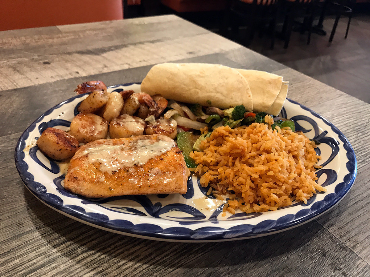Roberto's especial features a hearty serving of salmon, scallops, rice and veggies.