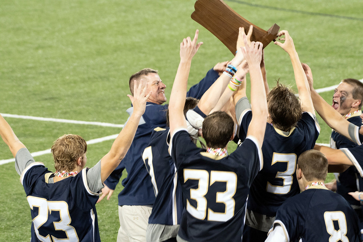 Severna Park head coach Travis Loving handed the championship trophy to his players.