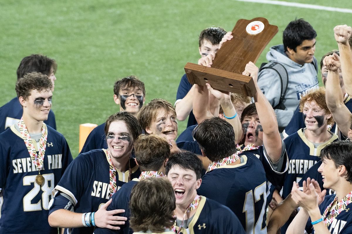 Several players triumphantly displayed the state championship trophy.