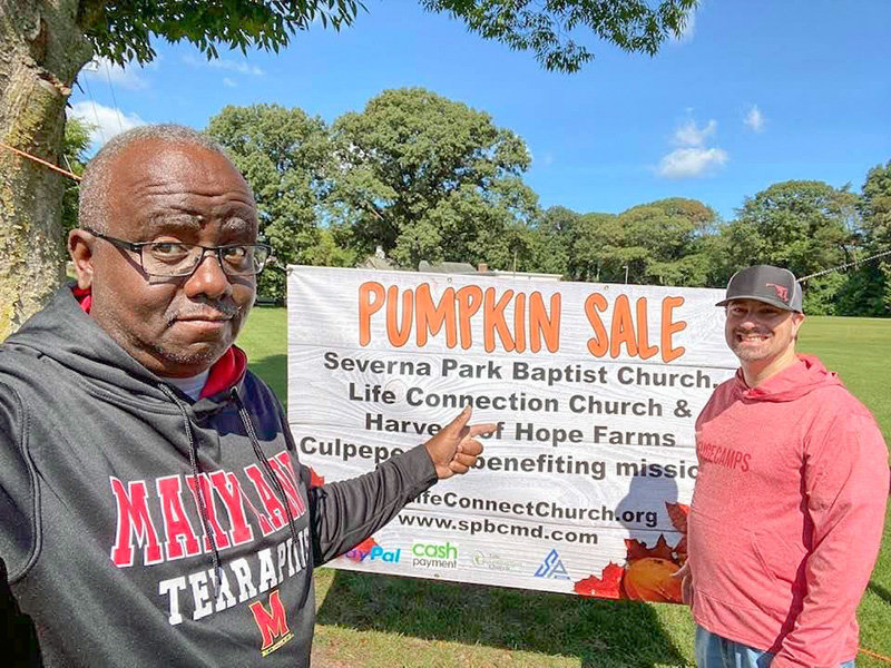 The Rev. Marty Bennett (left), the pastor of Life Connection Church, and Dave Brown, the pastor of Severna Park Baptist Church, are working together to sell pumpkins to raise funds for mission projects.