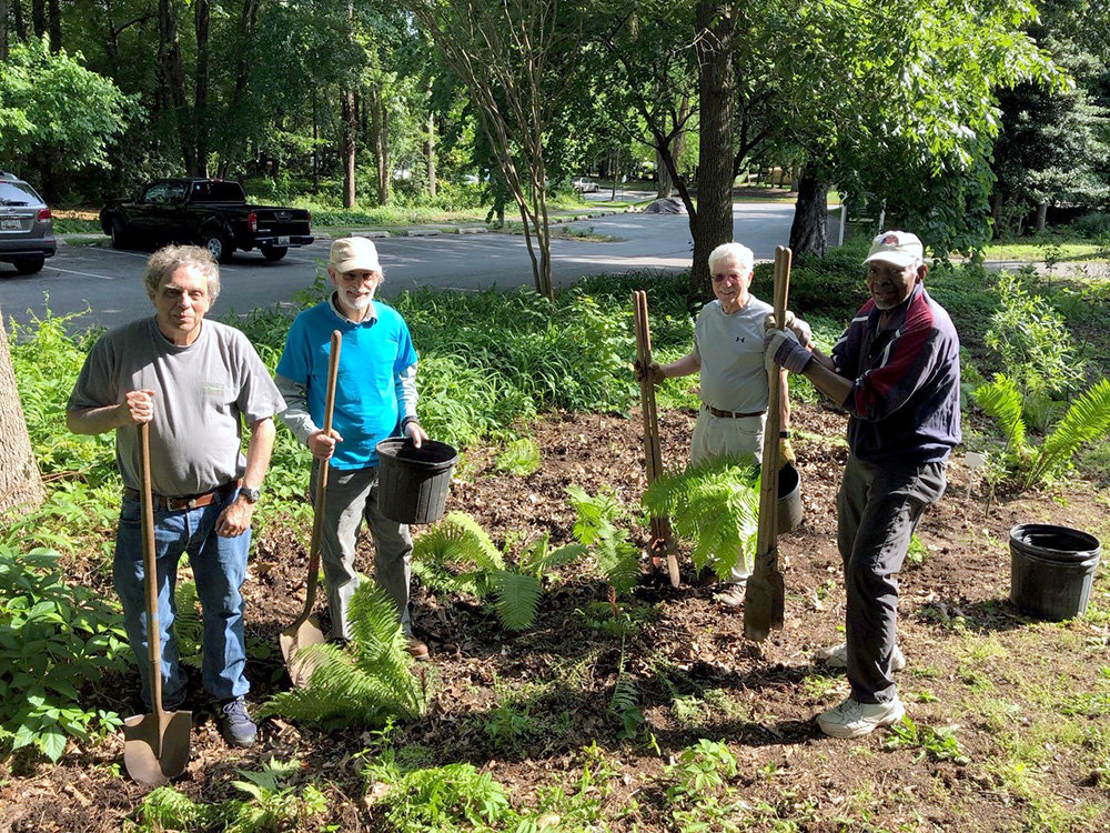 Many volunteers helped upgrade the Woods campus, removing grass areas and invasive plants.