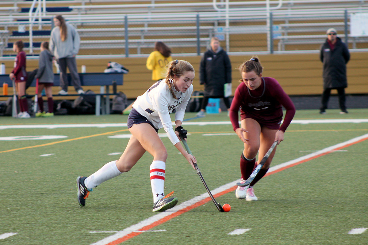 Zoe Day carried the ball upfield as a Bruins player tried to poke the ball away.