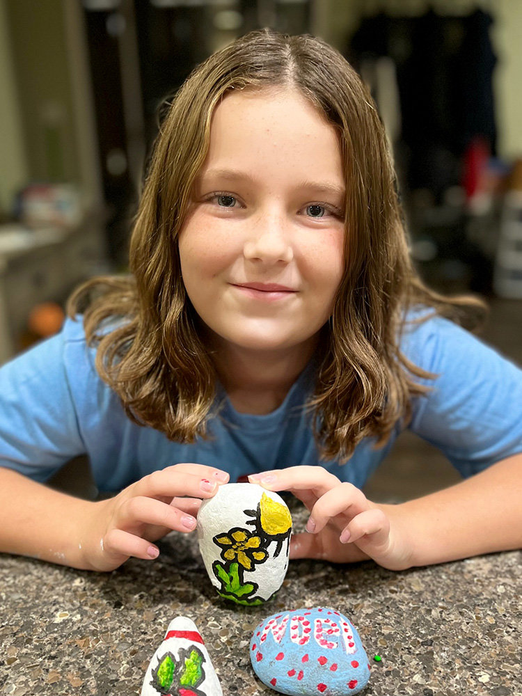 Maddelyn Ramsey and her sister, Emma, painted kindness rocks to place around the community.