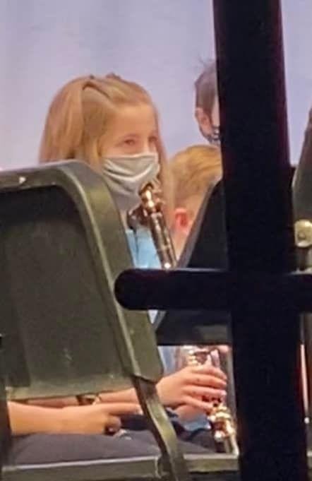 Elaiza Albin, a fourth-grader at Tracy’s Elementary School, wore a face mask while playing clarinet during a school concert on December 15.