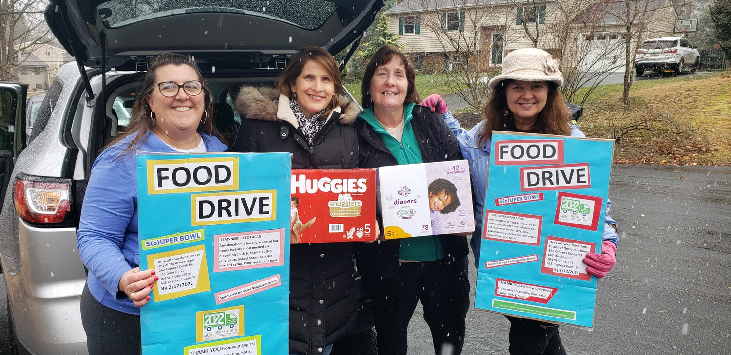 (L-R) Krys Milewski, Sue Powell, Abbie Ellicott and Katie McCord collected items on behalf of the Cypress Creek neighborhood. Milewski, Ellicott and McCord have led their neighborhood every year for the S(o)uper Bowl food drive.