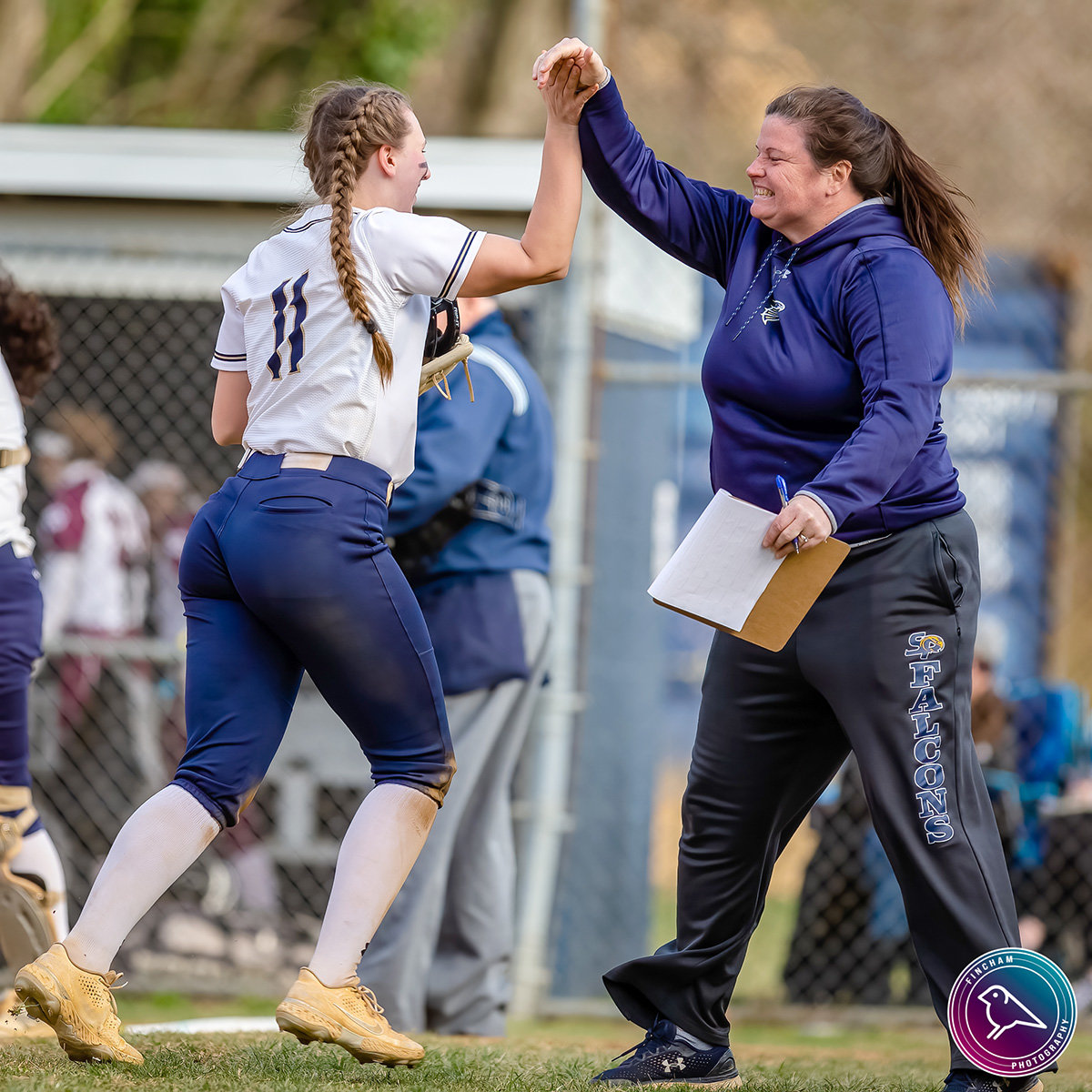 Severna Park head coach Meredith McAlister congratulated third baseman Livi Driver during the team’s 9-2 win over Broadneck.