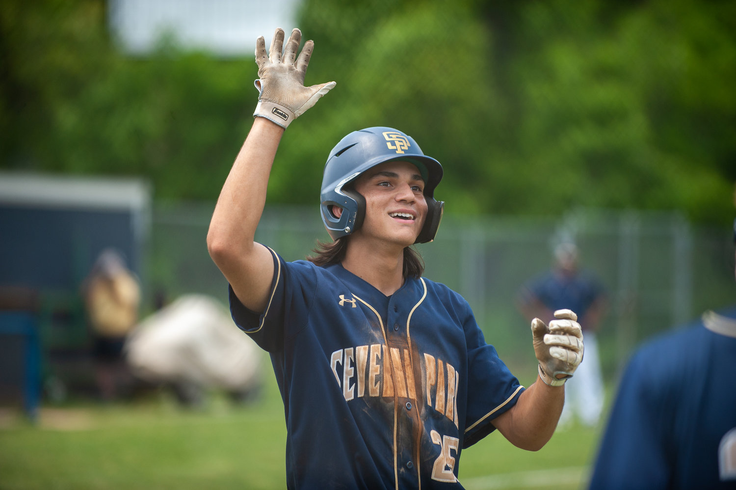 Angel Santiago-Cruz prepared to high-five teammates after his second home run of the state quarterfinals on May 20.
