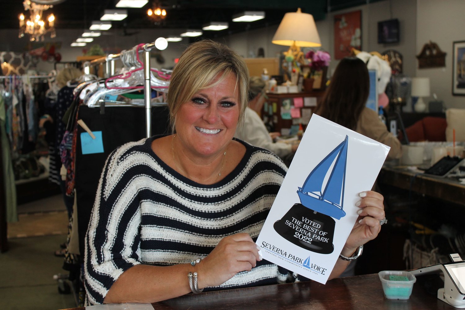 Stacey Cassidy, owner of Savvy Consignment, received her decal for Best Consignment Shop.