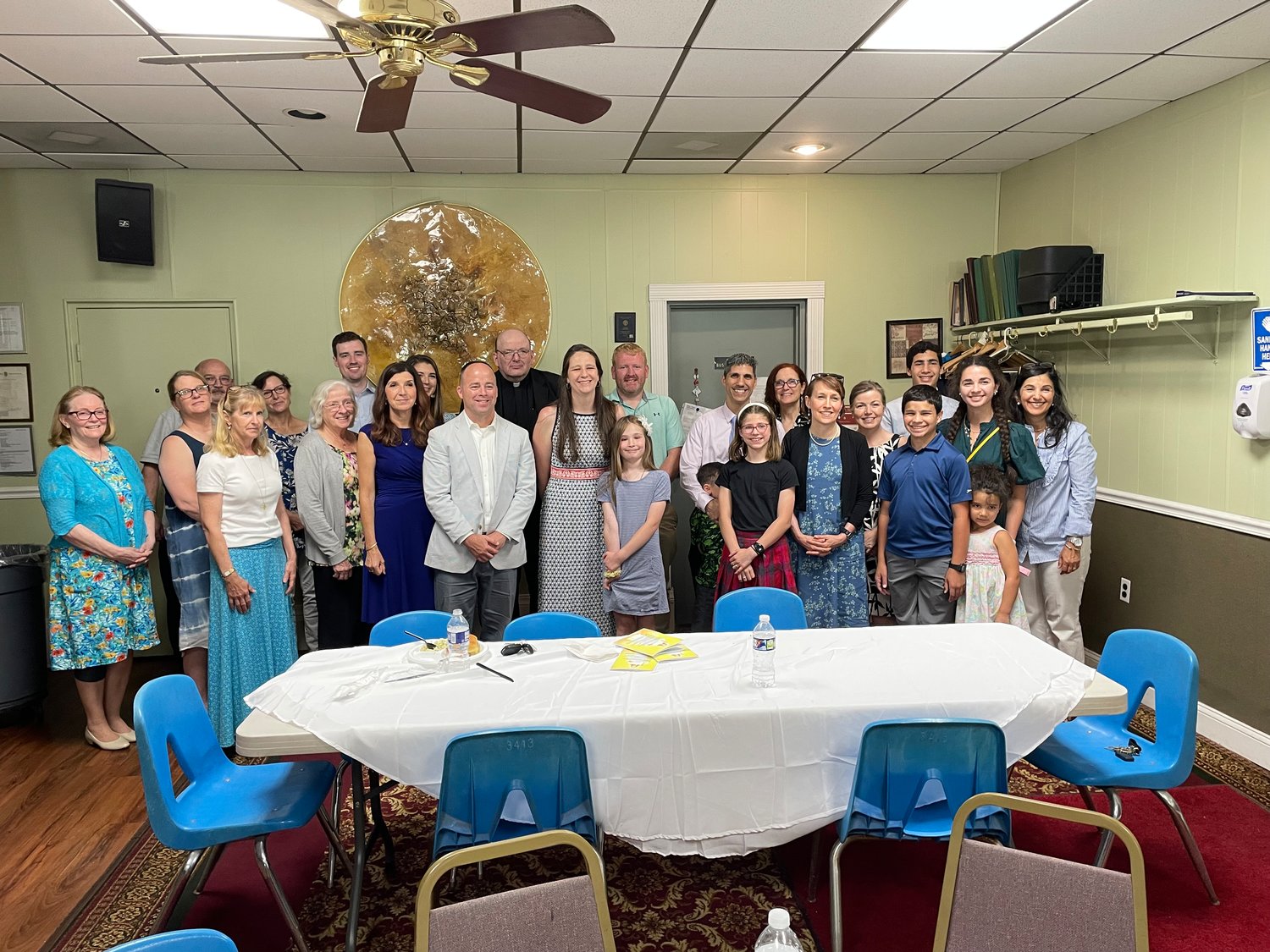 Teacher of the Year honorees Tim Feeney (middle, white jacket) and Susie Hughes (middle, black-and-white dress) were surrounded by family and friends at the KOC local heroes lunch on June 4 at the Columbian Center.