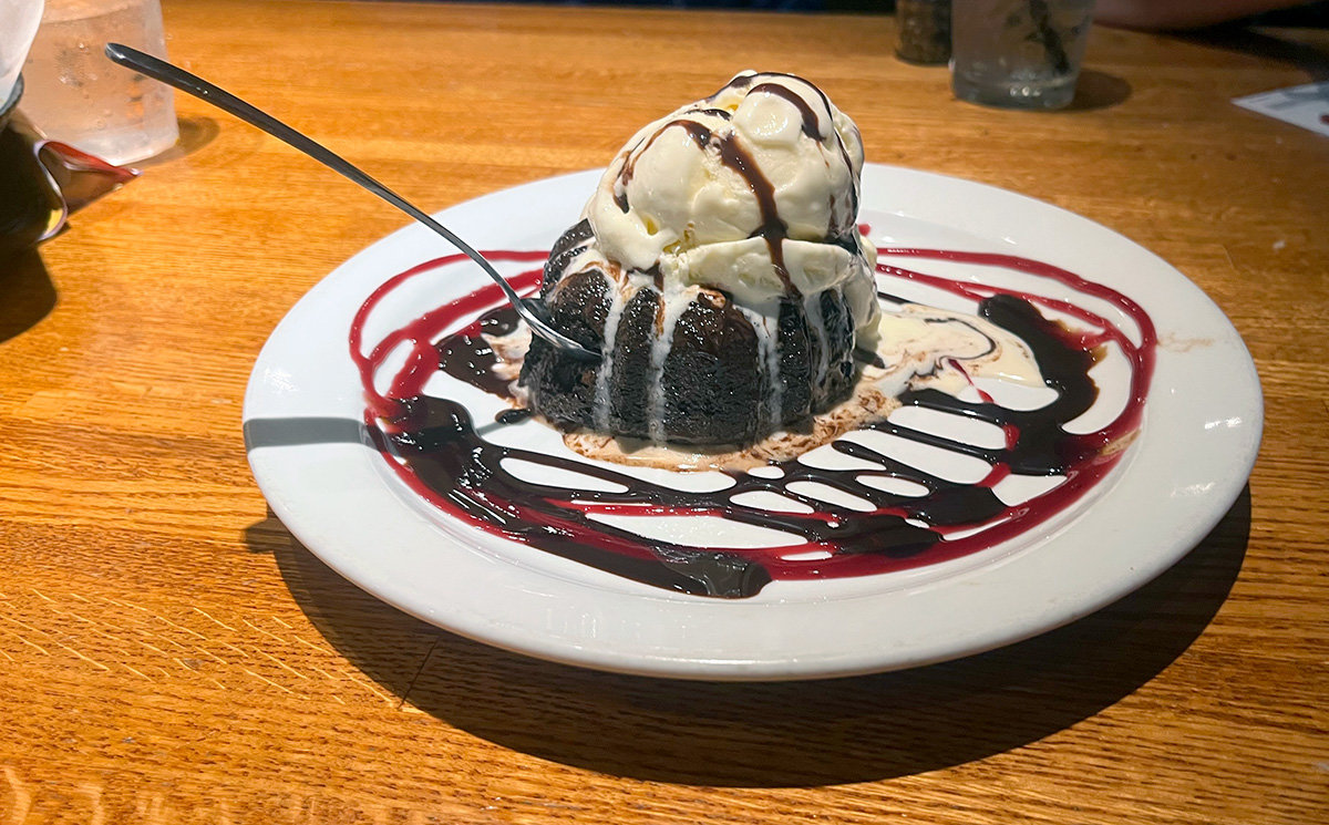 Super soft and filled with gooey chocolate, the lava cake includes a generous scoop of vanilla ice cream and drizzles of chocolate and raspberry.