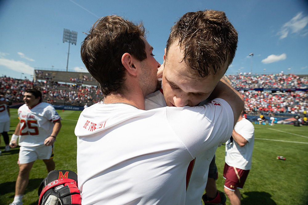 Josh Coffman hugged Terps star Logan Wisnauskas after winning the 2022 NCAA men’s lacrosse title.