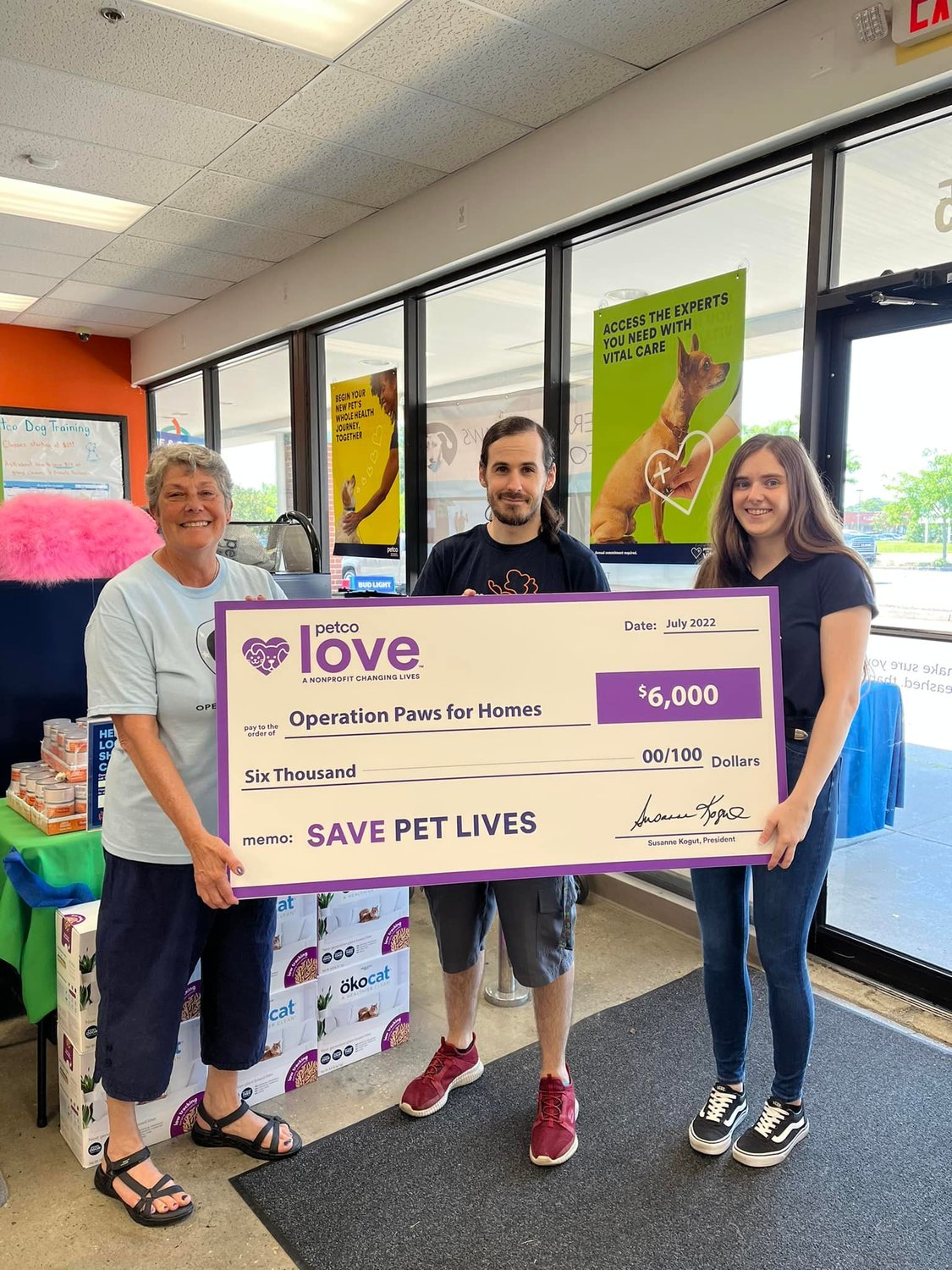 Operation Paws for Homes volunteer Nita Dressel received the Petco Love check from Severna Park Petco employees Steven Median and Amanda Clarke on July 12.