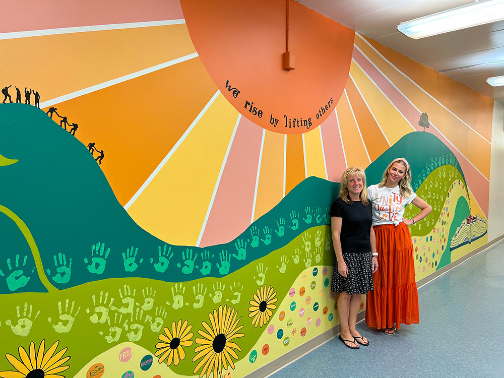 Oak Hill Elementary Principal Deneen Houghton (left) and library media specialist Jackie Phelan are proud of the student-made mural.