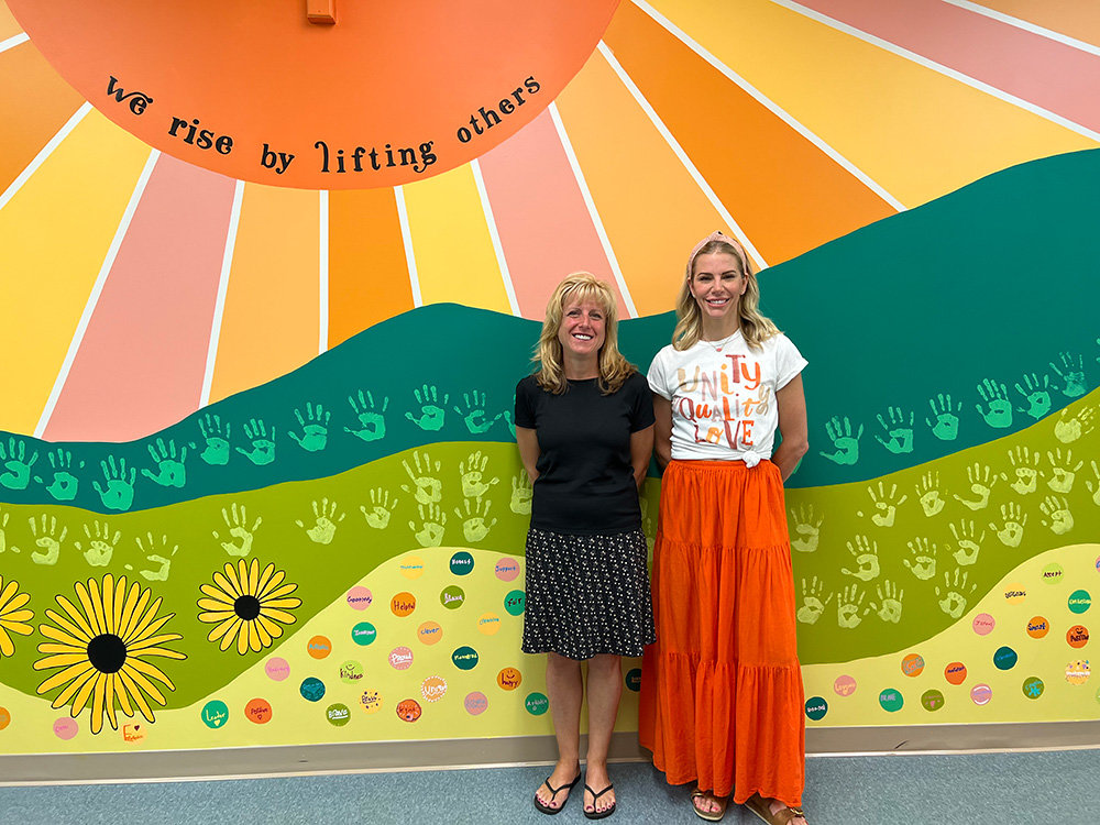 Oak Hill Elementary Principal Deneen Houghton (left) and library media specialist Jackie Phelan are proud of the student-made mural.