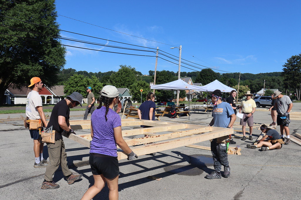 The WoodsWork team constructed walls in an offsite parking lot before taking them back to the house.