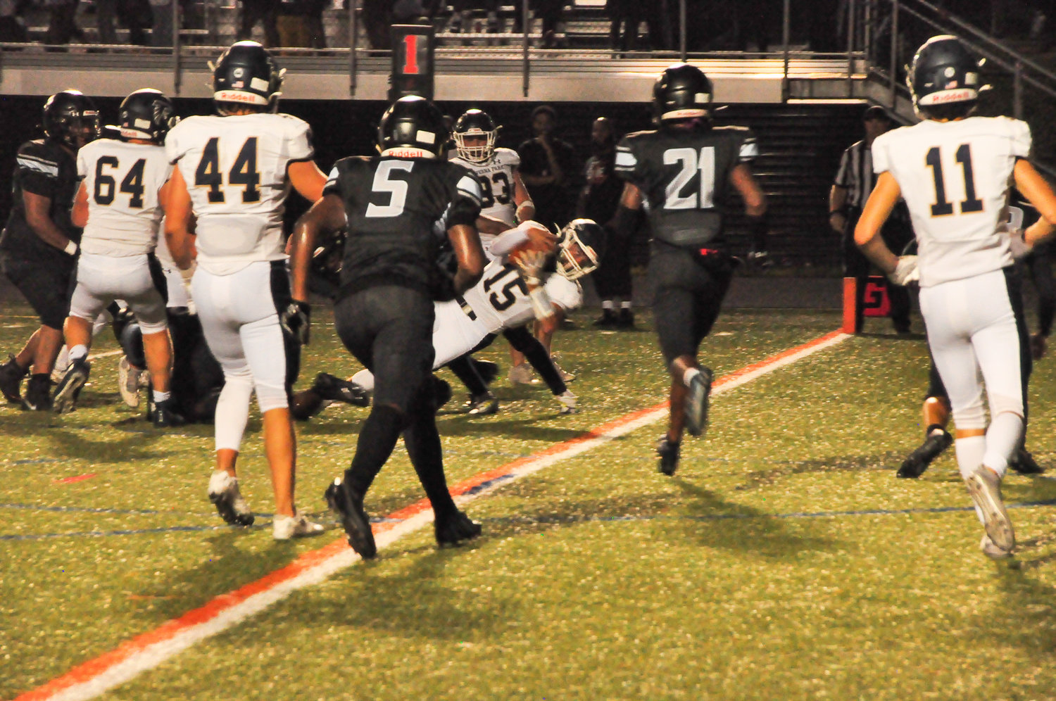 Seamus Patenaude (center) dove into the end zone to score a 5-yard rushing touchdown.