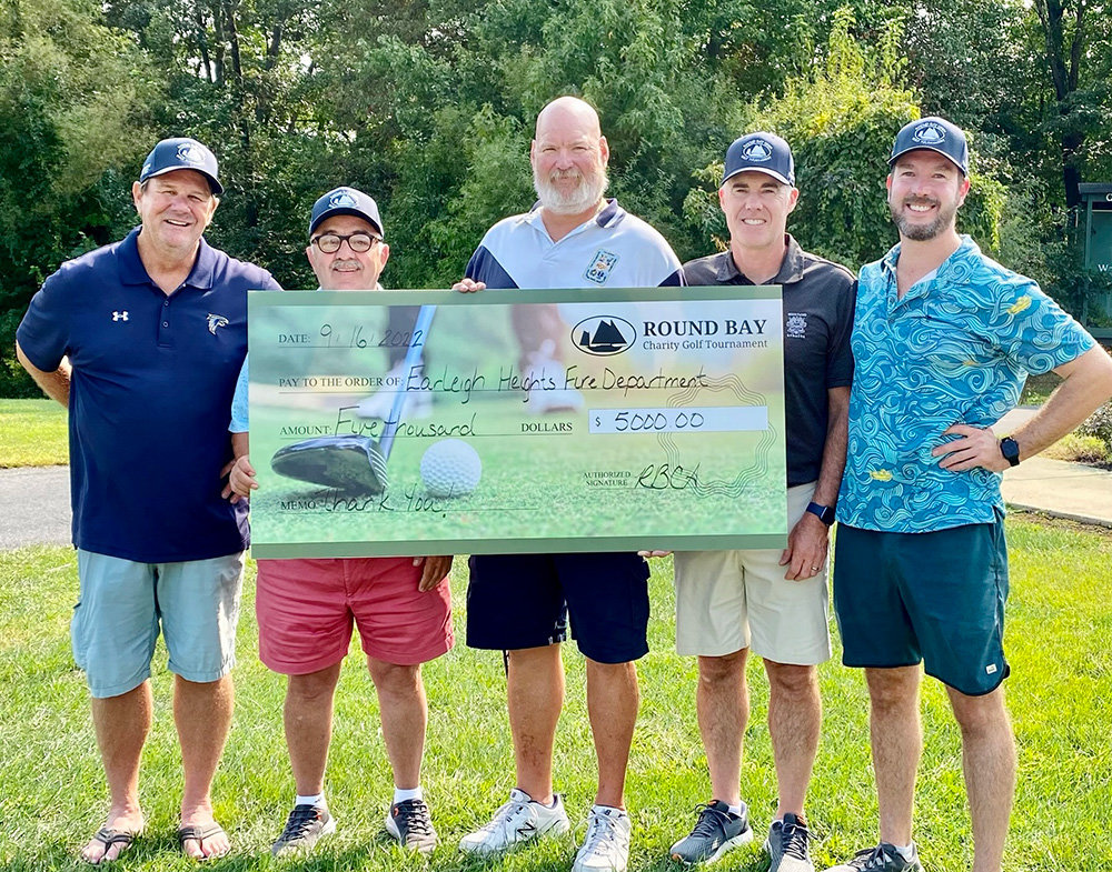Committee members Dan Flagler, Korky Onal, Erin Gruver and Howard Carolan presented the $5,000 check to Mike Sohn, vice president of the Earleigh Heights Volunteer Fire Company.
