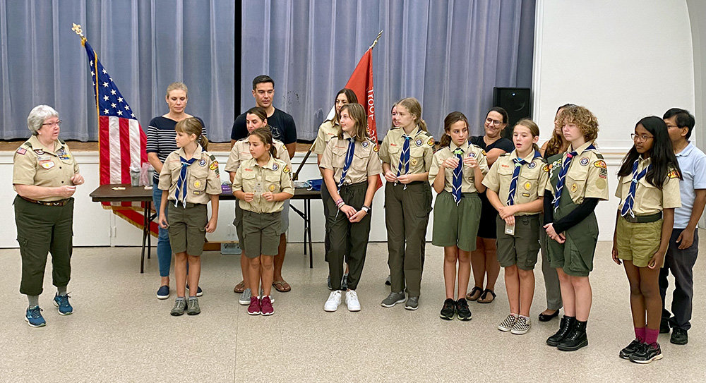 Scouts BSA Troop 1983 of Severna Park held its first ever Court of Honor on September 21. Advancement chair Sally Dugenske (left) commended the eight young women who earned Scout rank, the first step on the trail to Eagle.