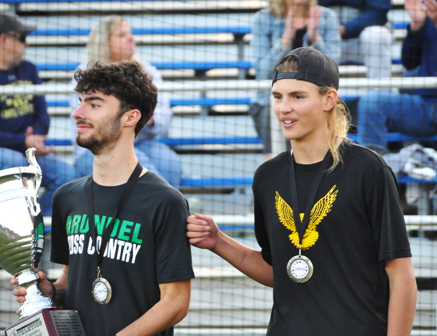 Severna Park High School junior Taylor Jarvis (right) congratulated Arundel High School junior Zaiden Lane at the county cross country championship award ceremony at South River High School on October 26. Lane was the top finisher in the boys race with a time of 16:34.0. Jarvis finished in second place with a time of 16:39.8.